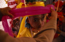 Novice monk at ordination ceremony at Wat Chiang Yuen having ornate head dress put on.