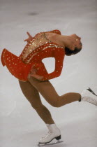 Female ice skater on  one skate with back arched