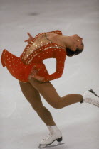 Female ice skater on  one skate with back arched
