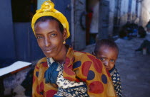 Woman carrying a child on her back  portrait.