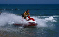 Man riding a jet ski on the sea at Littlehampton in West Sussex  England.