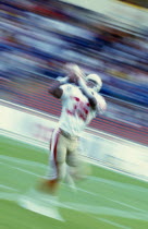 American Footballer catching ball in motion blur