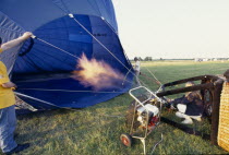 Inflating balloon with gas flame on the ground in Hedcorn Kent.