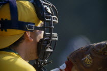 Portrait of catcher wearing protective helmet with mask and golve.