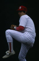 Pitcher preparing to throw ball.