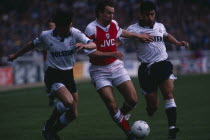 Players tackle in Arsenal versus Spurs match.