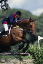 French rider Herve Godignon clearing a fence at Hickstead on a bay horse.