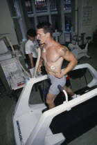 V02 maximum endurance testing  man being monitored on treadmill.