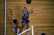 Basketball Player taking a shot at basket,