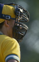 Portrait of catcher wearing protective helmet with mask