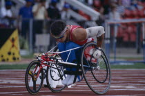 Disabled athlete lining up the front wheel of his wheelchair on the racing track.