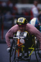 Disabled competitor in a racing wheelchair during the London Marathon.