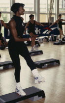 A young black woman taking part in a step workout