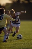 Children playing in a game of football