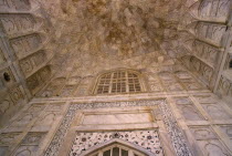 Taj Mahal built 1631-1653.  Interior detail of marble walls and ceiling inlaid with semi-precious stones using process known as pietra dura and arabic script.seventeenth century  17th c. Mughal  tomb...