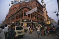 Nakhoda mosque built 1926.  Calcutta s principal Muslim place of worship.  Red sandstone exterior with painted dome on busy street with people  traffic and shop fronts.Asia Asian Bharat Inde Indian I...