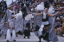 Crop Over sugar cane harvest festival  Kadooment carnival parade dancers in black and white costumes Barbadian West Indies