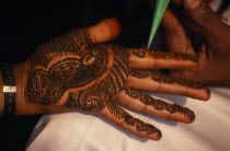 Hand of bride being decorated with henna paste for wedding.Asia Asian Bharat Inde Indian Intiya Marriage Religion Religion Religious Hinduism Hindus