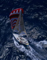 Aerial view over people on yacht  sailing across the sea