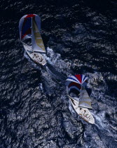 Aerial view over two yachts sailing at speed along the sea