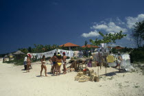 Stall on beach selling T-shirts and tourist goods.Beaches Holidaymakers Jamaican Resort Sand Sandy Seaside Shore Sightseeing Sunbather Tourism Tourists Travel West Indies