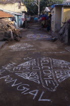 Pongal Festival.  Four day festival to mark the end of harvest.  Painted welcome signs and decorative patterns on narrow street.  4 Asia Asian Bharat Inde Indian Intiya Religion