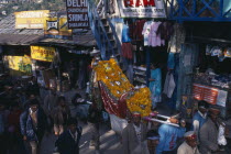 Figures of temple gods garlanded with flowers being carried through street during Hindu Dussehra festival.Asia Asian Bharat Inde Indian Intiya Religion Religion Religious Hinduism Hindus