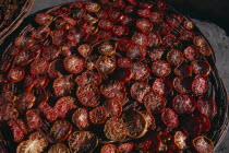Sun dried tomatoes in large  shallow baskets.Asia Asian Farming Agraian Agricultural Growing Husbandry  Land Producing Raising Pakistani