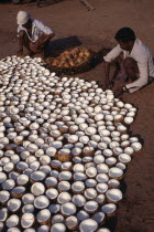 Men preparing copra or dried coconut.Asia Asian Bharat Farming Agraian Agricultural Growing Husbandry  Land Producing Raising Inde Indian Intiya Kerela Male Man Guy