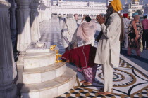 Golden Temple.  Barefooted Sikh pilgrims praying at shrine.worship Asia Asian Bharat Inde Indian Intiya Religion Religion Religious Sihism Sikhs