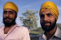 Two Sikh men  head and shoulders portrait wearing orange turbans.2 Asia Asian Bharat Inde Indian Intiya Male Man Guy Religion Religion Religious Sihism Sikhs