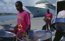 The Halcyon Cove Steel Band playing on quayside with cruise ship behind.Caribbean West Indies