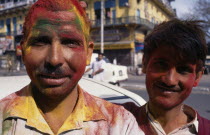 Two men covered with powder paint dyes during Holi Festival