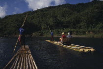 Tourists on bamboo raft.Holidaymakers Jamaican Tourism West Indies