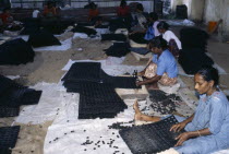 Female workers on floor of factory making rubber mats.Asia Asian Bharat Inde Indian Intiya Kerela