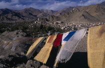 View over Leh Valley and town from hill-top with line of prayer flags flying in wind in foreground.Asia Asian Bharat Inde Indian Intiya Religion Religious Scenic