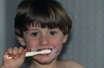 Boy brushing his teeth.