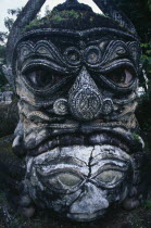 Buddha Park.  Detail of fierce stone sculpture face.