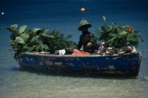 Beach vendor selling fruit from boat Beaches Caribbean One individual Solo Lone Solitary Resort Sand Sandy Seaside Shore Tourism West Indies Windward Islands