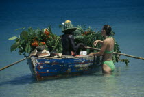 Beach vendor selling fruit from boat Beaches Caribbean Holidaymakers Resort Sand Sandy Seaside Shore Tourism Tourist West Indies Windward Islands