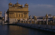 Golden Temple. Pilgrims and visitors on causeway known as the Guru s Bridge approaching temple.Asia Asian Bharat Inde Indian Intiya Religion Religious