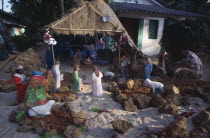 Young girl looking at Christmas nativity scene on sand.Asia Asian Bharat Immature Inde Indian Intiya Kids One individual Solo Lone Solitary Religion Religious Xmas