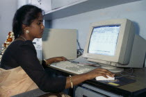 Young Indian woman using computer.