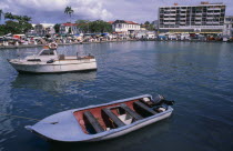 Grande Terre  Pointe-a-Pitre.  Moored boats with busy quay and town buildings behind.Caribbean Guadeloupean West Indies