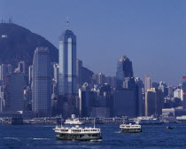 Star Ferries sailing away from the city skyline behind