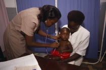 Woman doctor examing infant at Kawempe clinic