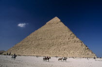 Pyramid of Khufu with horse and donkey renters passing byEquestrian History Holidaymakers Middle East North Africa Tourism Tourist