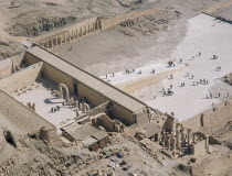 Hatshepsut Mortuary Temple. Deir el-Bahri. Elevated view from limestone cliffs over the temple with visitors walking towards ramped entrance African History Holidaymakers Middle East North Africa Tou...