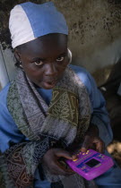 Portrait of a local child playing a hand held computer game