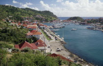View over the port with yachts on water and houses built along bottom of hillsideSt Barts Scenic West Indies
